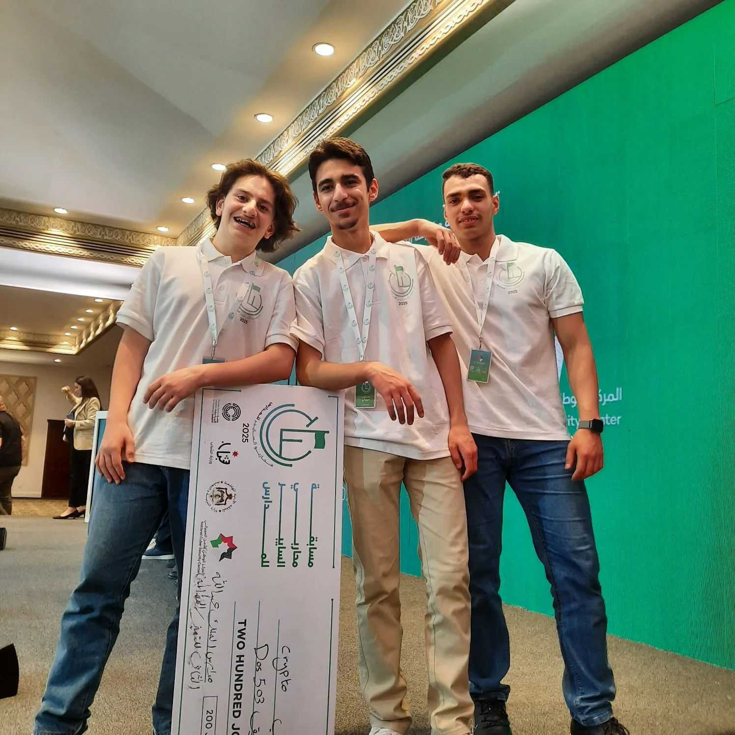 Three DoS_Team members holding a competition award